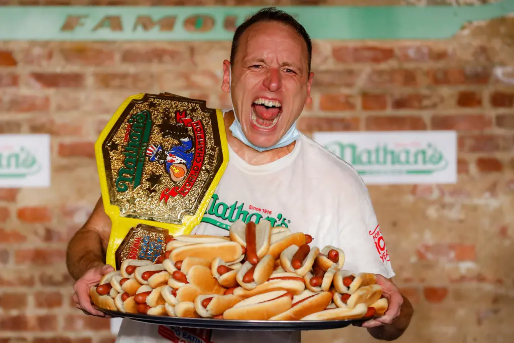 Joey Chestnuts Holds the Mustard Belt and a Tray of Nathans Hotdogs